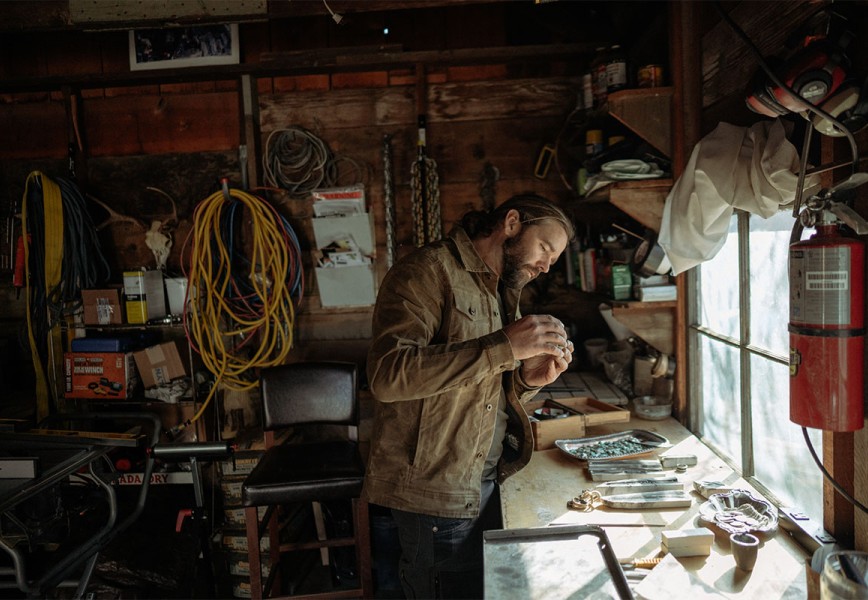 Tobias Corwin making jewels in his workshop.