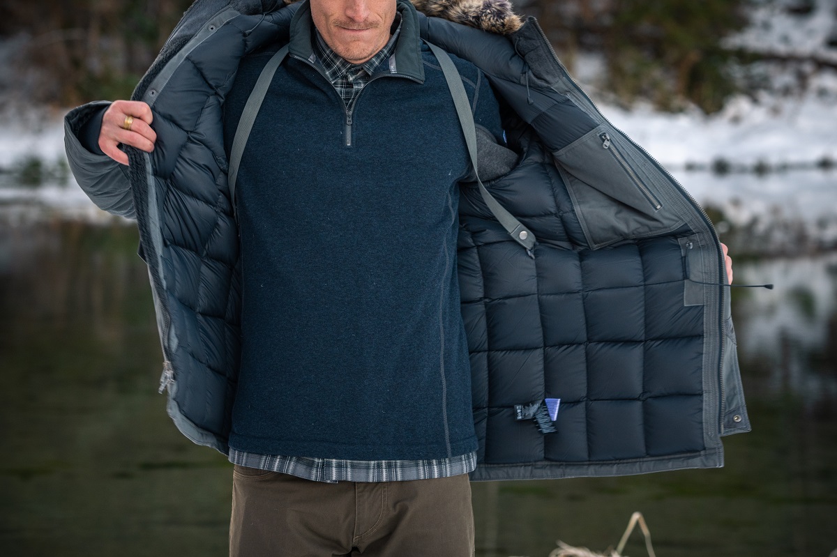 man in K&Uuml;HL Arktik Down Parka and K&Uuml;HL Thor Quarter Zip in winter snow