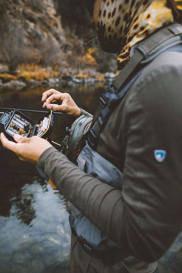man holding a box of fishing lure