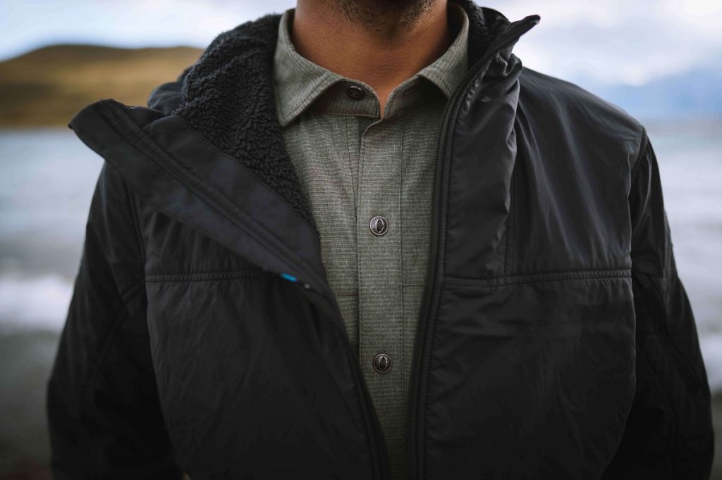 man in black jacket with gray shirt under