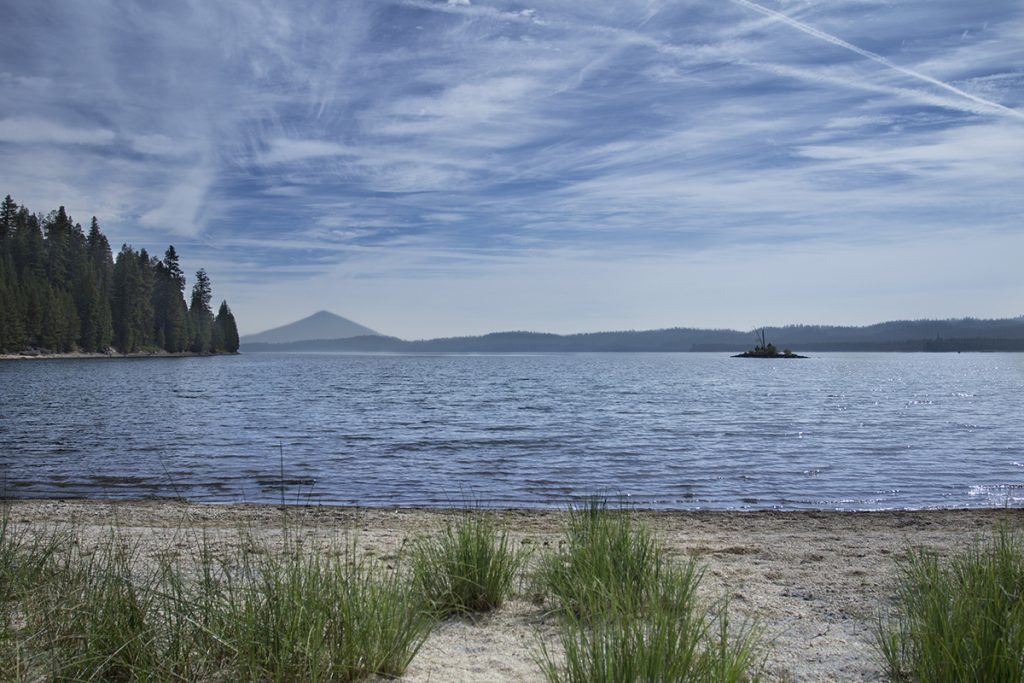 body of water under blue sky