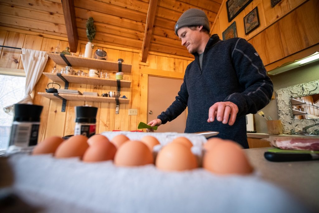 man in K&Uuml;HL Thor 1/4 Zip next to eggs
