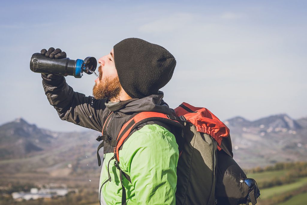 hiker on an excursion in the nature - Tourist having a pause while on a trekking tour.